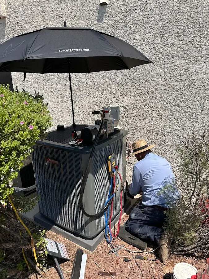 HVAC technician performing outdoor AC maintenance in Birch Run
